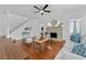 Bright living room boasts hardwood floors, fireplace, ceiling fan, and ample seating at 2306 Trelain S Dr, St Petersburg, FL 33712