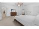 Large main bedroom featuring a dresser, ceiling fan, and entry to the ensuite at 2306 Trelain S Dr, St Petersburg, FL 33712