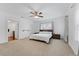 Spacious main bedroom with a ceiling fan, neutral carpet, and two bedside tables at 2306 Trelain S Dr, St Petersburg, FL 33712