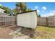Backyard shed with a wooden fence, providing storage space and enhancing the property's functionality at 2306 Trelain S Dr, St Petersburg, FL 33712