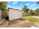 Outdoor shed with a wooden fence, conveniently located in the backyard for storage and organization at 2306 Trelain S Dr, St Petersburg, FL 33712