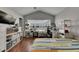 Bright bedroom features a large window, wood floors, and vaulted ceilings at 26610 Castleview Way, Wesley Chapel, FL 33544