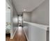 Upstairs hallway with wood floors and neutral walls connecting the bedrooms at 26610 Castleview Way, Wesley Chapel, FL 33544