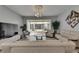 Bright living room features neutral tones, tile flooring, modern lighting, and access to an enclosed patio at 26610 Castleview Way, Wesley Chapel, FL 33544