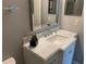 Bathroom vanity with a marble countertop and decorative elements at 2720 Sand Hollow Ct # 156A, Clearwater, FL 33761