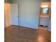 Bedroom with warm wood flooring leading to an ensuite bathroom at 2720 Sand Hollow Ct # 156A, Clearwater, FL 33761