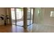 Living room with tile and wood flooring, and a view to the patio at 2720 Sand Hollow Ct # 156A, Clearwater, FL 33761