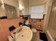 Bathroom with a vintage pink and black tile scheme, featuring a sink, toilet, and mirror at 2900 Dr Martin Luther King Jr S St, St Petersburg, FL 33705