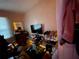 Bedroom with a TV, shoe rack, desk, and string lights creating a cozy ambiance at 2900 Dr Martin Luther King Jr S St, St Petersburg, FL 33705