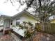 Exterior view showing the side of the house with mature landscaping and a view of the front porch at 2900 Dr Martin Luther King Jr S St, St Petersburg, FL 33705