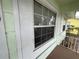 Close-up of an exterior window featuring traditional trim and a view of the porch at 2900 Dr Martin Luther King Jr S St, St Petersburg, FL 33705