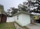 Side view of the home showing its simple structure, small window, and access to a fenced backyard at 2900 Dr Martin Luther King Jr S St, St Petersburg, FL 33705