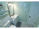 Bathroom with vanity, mirror, open shelving, tile floors and pastel green walls at 300 6Th N St # E3, Safety Harbor, FL 34695