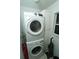 Convenient laundry area with stacked washer and dryer and built-in storage cabinet at 300 6Th N St # E3, Safety Harbor, FL 34695
