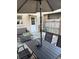 Back patio with patio furniture, view of door to interior, fence and awnings at 300 6Th N St # E3, Safety Harbor, FL 34695