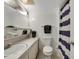 Cozy bathroom featuring a toilet, sink, and shower with striped curtain at 31 Island Way # 1403, Clearwater Beach, FL 33767