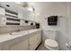 Bathroom featuring a single sink vanity, white toilet, and shower-tub combination at 31 Island Way # 1403, Clearwater Beach, FL 33767