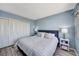 Comfortable bedroom featuring a large bed, white closet doors, and soothing blue walls at 31 Island Way # 1403, Clearwater Beach, FL 33767