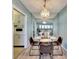 Charming dining room featuring a glass table, mirrored wall, vintage lighting, and view of the water at 31 Island Way # 1403, Clearwater Beach, FL 33767