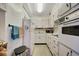 Compact kitchen featuring white appliances, cabinets and tiled floors at 31 Island Way # 1403, Clearwater Beach, FL 33767