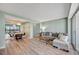Bright living room features wood floors, comfortable seating, and dining room with city views at 31 Island Way # 1403, Clearwater Beach, FL 33767