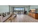 Comfortable living room with a large sectional sofa, wood floors, and a view of the water at 31 Island Way # 1403, Clearwater Beach, FL 33767