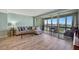 Living room with sectional sofa leading out to a screened balcony with city views at 31 Island Way # 1403, Clearwater Beach, FL 33767