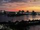 Stunning water view from a high-rise condominium at dusk with the city skyline aglow in the evening light at 31 Island Way # 1403, Clearwater Beach, FL 33767