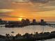 City skyline view at sunset, with silhouetted buildings reflecting the golden light over the water at 31 Island Way # 1403, Clearwater Beach, FL 33767