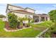 Well-maintained backyard featuring lush green grass and a beautiful pergola with potted plants at 3212 Calvano Dr, Land O Lakes, FL 34639