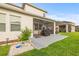 Spacious backyard with a screened patio, landscaping, and a charming sandbox at 3212 Calvano Dr, Land O Lakes, FL 34639