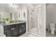 Bathroom with a glass enclosed shower, modern sink, and decorative lighting at 3212 Calvano Dr, Land O Lakes, FL 34639