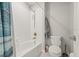 Bathroom featuring tiled shower, white fixtures, and light gray walls at 3212 Calvano Dr, Land O Lakes, FL 34639