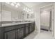 Bathroom with double vanity, dark cabinets and a separate shower at 3212 Calvano Dr, Land O Lakes, FL 34639