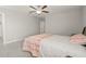 Bedroom featuring neutral walls, gray carpet, ceiling fan, and wood furniture at 3212 Calvano Dr, Land O Lakes, FL 34639