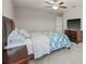 Bedroom featuring neutral walls, gray carpet, ceiling fan, and wood furniture at 3212 Calvano Dr, Land O Lakes, FL 34639
