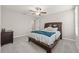 Bedroom featuring neutral walls, gray carpet, ceiling fan, and wood furniture at 3212 Calvano Dr, Land O Lakes, FL 34639