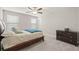 Bedroom featuring neutral walls, gray carpet, ceiling fan, and windows with wood trim blinds at 3212 Calvano Dr, Land O Lakes, FL 34639