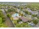 Aerial view of the community pool with palm trees, cabanas, and well-maintained landscaping at 3212 Calvano Dr, Land O Lakes, FL 34639