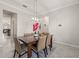 Dining room with a modern light fixture and large table creating a welcoming space for gatherings at 3212 Calvano Dr, Land O Lakes, FL 34639