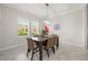 Dining room with a stylish light fixture and picture window, creating a warm and inviting atmosphere at 3212 Calvano Dr, Land O Lakes, FL 34639