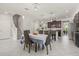 Eat-in kitchen, with modern cabinetry and stainless steel appliances, adjacent to the dining and stairway at 3212 Calvano Dr, Land O Lakes, FL 34639