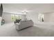 Expansive living room filled with natural light, plush carpet and a ceiling fan at 3212 Calvano Dr, Land O Lakes, FL 34639