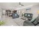 Bright, open living area with modern furniture and decor with an eat-in kitchen in the background at 3212 Calvano Dr, Land O Lakes, FL 34639
