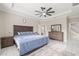 Spacious main bedroom featuring a tray ceiling, tiled floors, and stylish decor at 3212 Calvano Dr, Land O Lakes, FL 34639