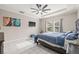 Large main bedroom with a ceiling fan, tray ceiling, tile floors, and a TV at 3212 Calvano Dr, Land O Lakes, FL 34639