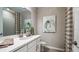 Well-lit bathroom featuring a framed mirror, shower/bath, and attractive decor at 33626 Castaway Loop, Wesley Chapel, FL 33543