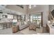 Open-concept living space with modern furniture and a high ceiling at 33626 Castaway Loop, Wesley Chapel, FL 33543