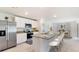 Modern kitchen with stainless steel appliances, granite countertops, and an adjacent dining area at 3529 Thistle Bank Ct, Plant City, FL 33565