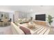 Spacious living room featuring plush seating, modern decor, and a seamless connection to the dining area at 3529 Thistle Bank Ct, Plant City, FL 33565